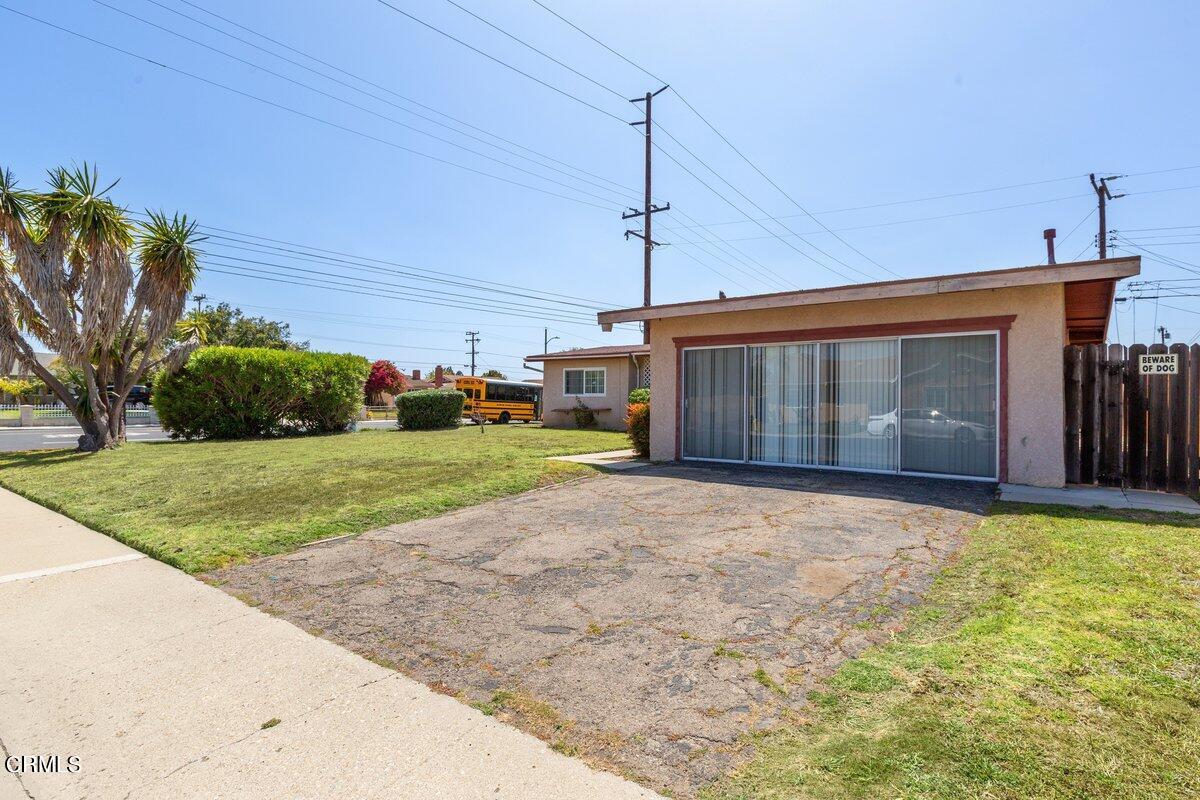 1931 Ukiah Street Oxnard, CA 93035 - Photo 2 of 21 a front view of a house with a yard and garage