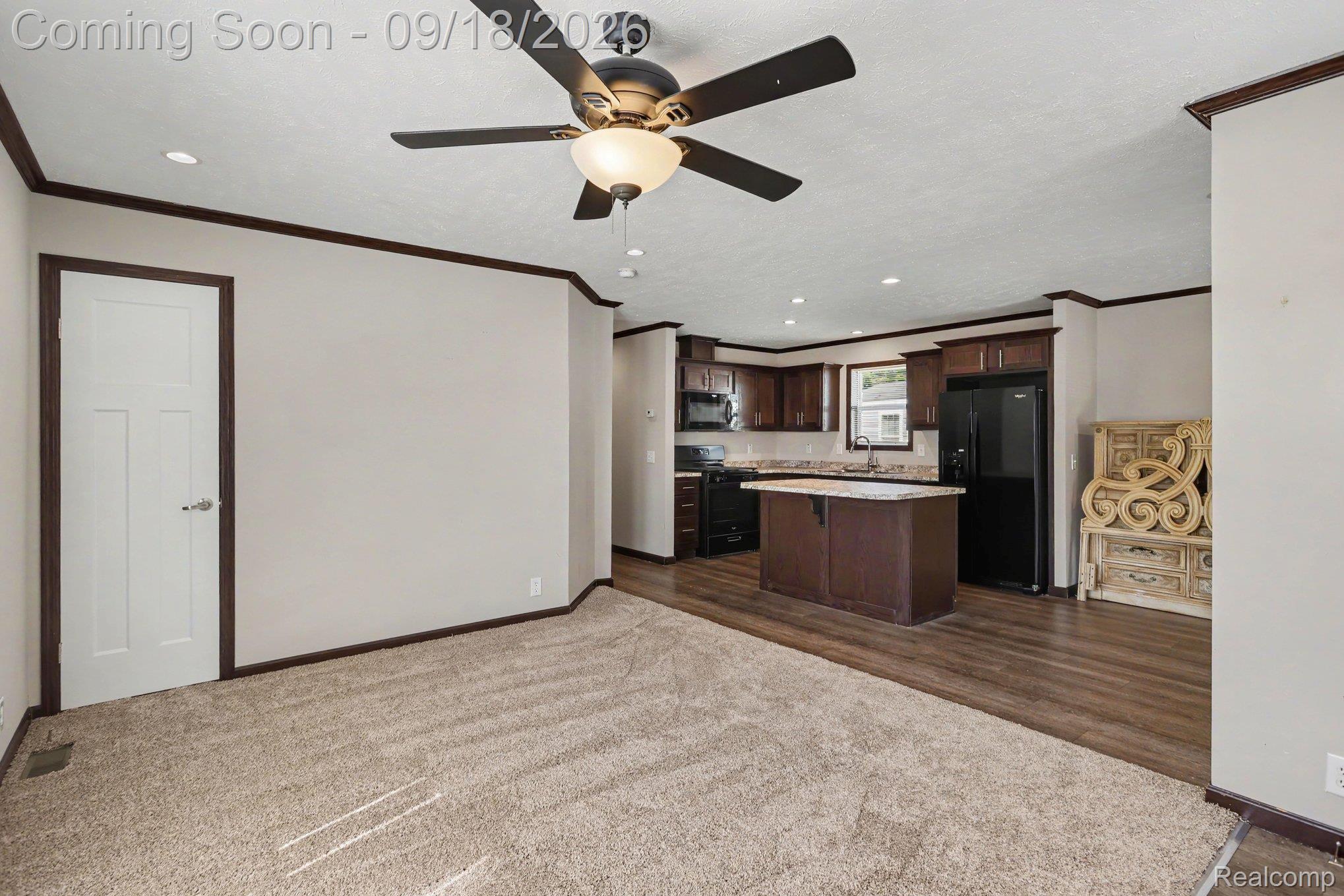 470 Flamingo Street Rochester, MI 48309 - Photo 3 of 17 Open-concept living space with plush carpeting, wood-finish flooring, and a ceiling fan