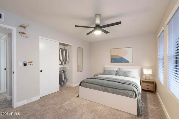 a bedroom with a bed and a chandelier