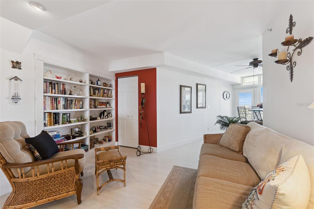 4621 South Atlantic Avenue, Unit 7506 Ponce Inlet, FL 32127 - Photo 11 of 46 a living room with furniture and a book shelf