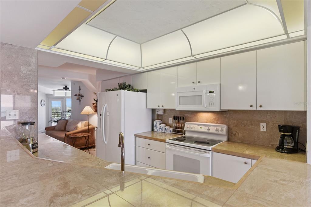 4621 South Atlantic Avenue, Unit 7506 Ponce Inlet, FL 32127 - Photo 13 of 46 a kitchen with stainless steel appliances a refrigerator sink and cabinets