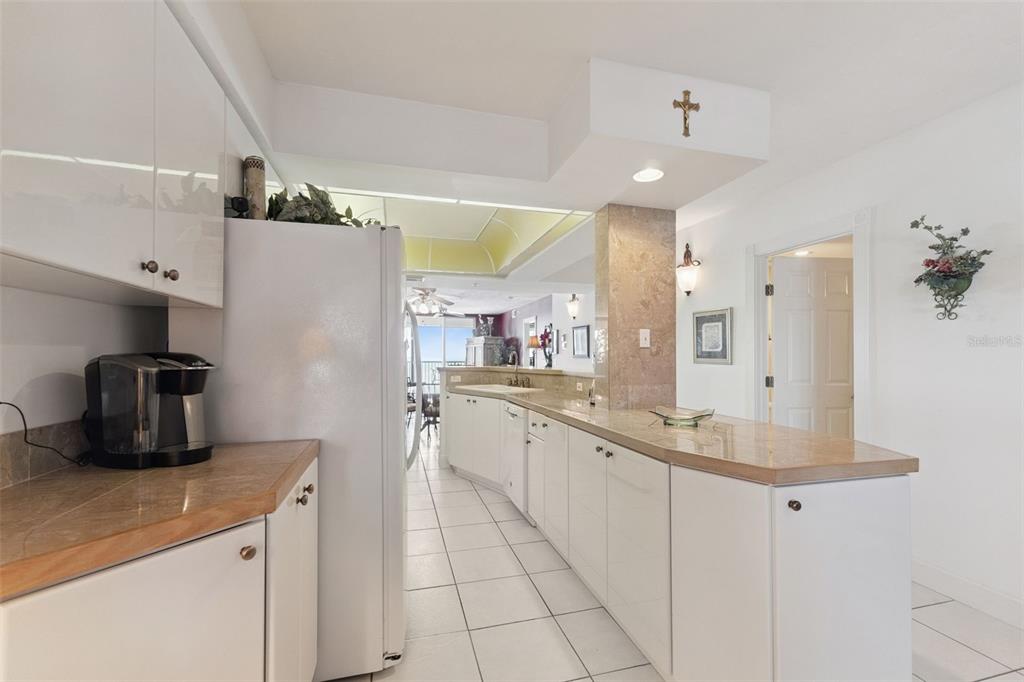 4621 South Atlantic Avenue, Unit 7506 Ponce Inlet, FL 32127 - Photo 17 of 46 a kitchen with stainless steel appliances granite countertop a sink a stove and a refrigerator
