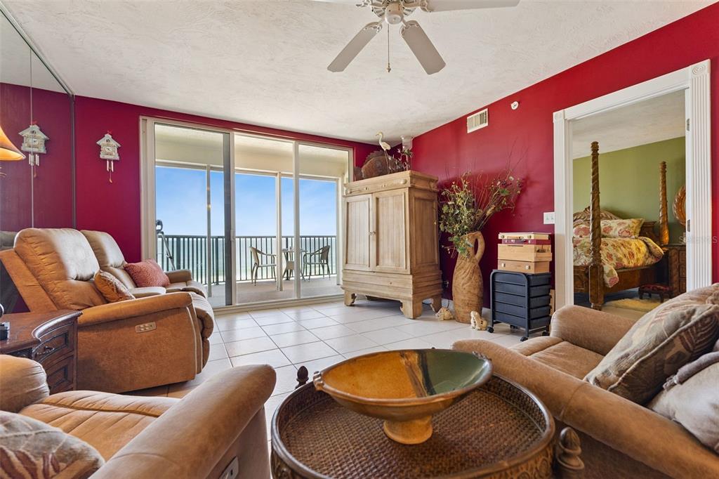 4621 South Atlantic Avenue, Unit 7506 Ponce Inlet, FL 32127 - Photo 20 of 46 a living room with furniture a rug and a large window