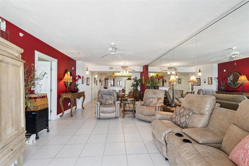 4621 South Atlantic Avenue, Unit 7506 Ponce Inlet, FL 32127 - Photo 22 of 46 a living room with furniture and a flat screen tv