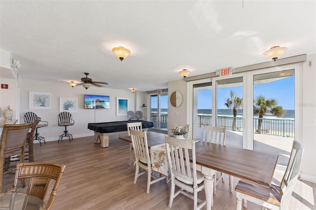 4621 South Atlantic Avenue, Unit 7506 Ponce Inlet, FL 32127 - Photo 38 of 46 a view of a dining room with furniture window and wooden floor