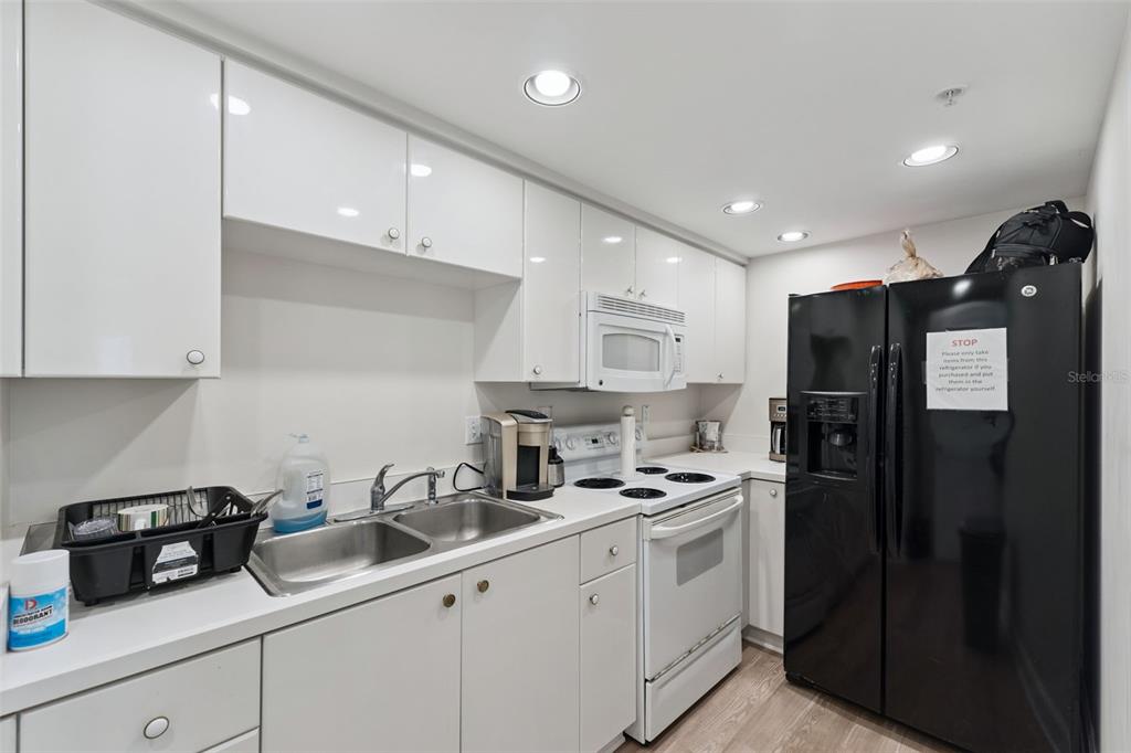 4621 South Atlantic Avenue, Unit 7506 Ponce Inlet, FL 32127 - Photo 40 of 46 a kitchen with a sink stainless steel appliances and cabinets