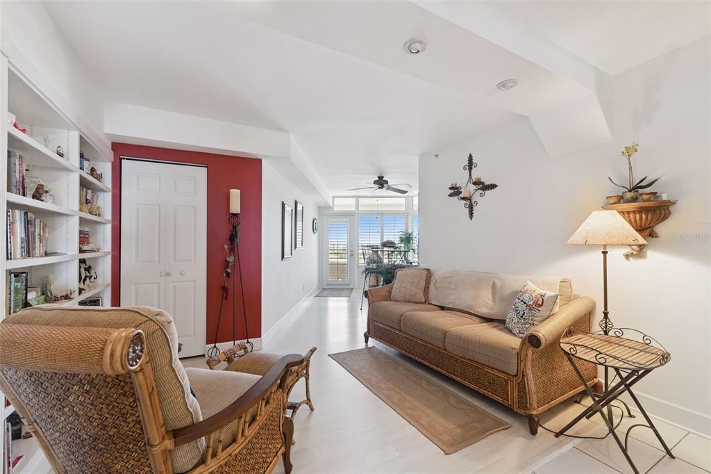 4621 South Atlantic Avenue, Unit 7506 Ponce Inlet, FL 32127 - Photo 10 of 46 a living room with furniture and a lamp