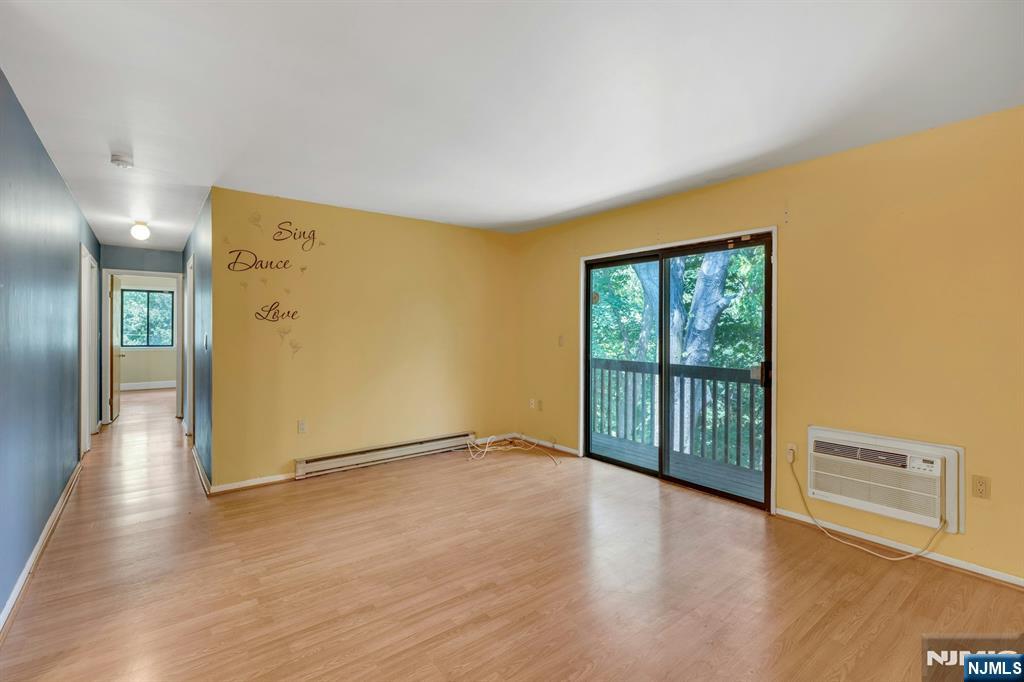 666 Mill Street, Unit C6 Belleville, NJ 07109 - Photo 4 of 25 a view of a big room with wooden floor and windows