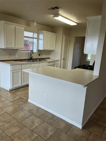 a kitchen with stainless steel appliances a sink stove and cabinets