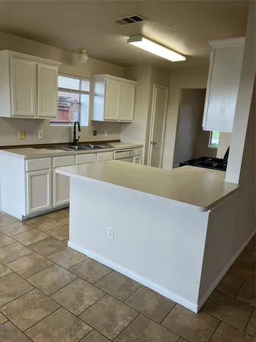 a kitchen with stainless steel appliances a sink stove and cabinets
