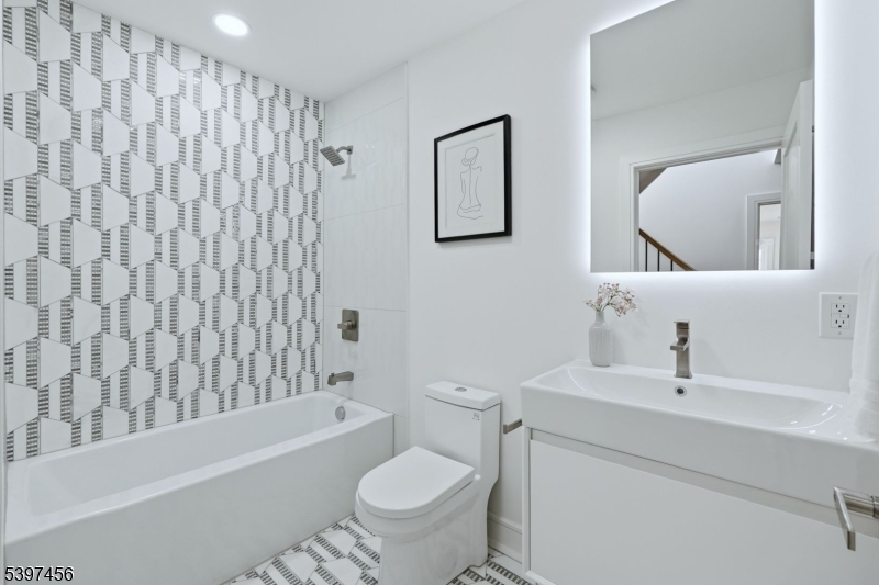 8 Mountainview Road Millburn, NJ 07041 - Photo 28 of 46 a bathroom with a toilet sink and bathtub