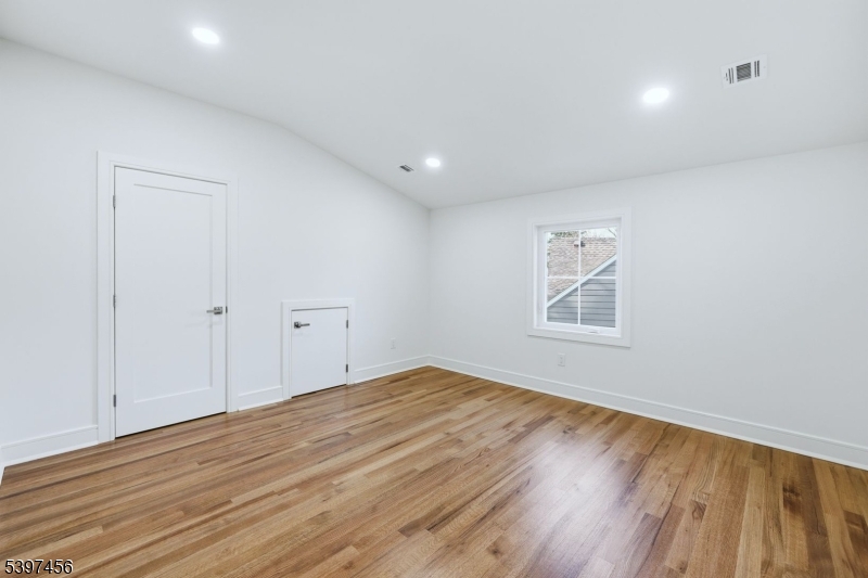 8 Mountainview Road Millburn, NJ 07041 - Photo 31 of 46 a view of an empty room with wooden floor and a window