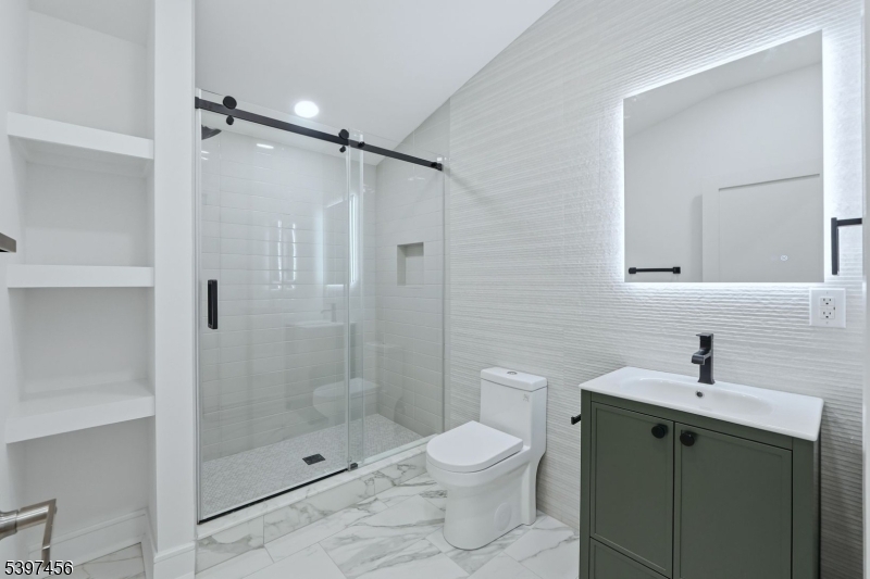 8 Mountainview Road Millburn, NJ 07041 - Photo 33 of 46 a bathroom with a shower sink mirror and toilet