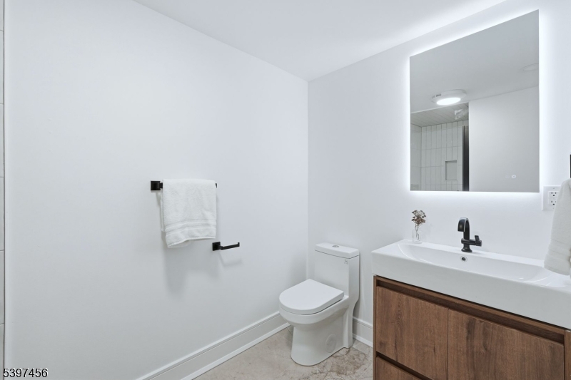 8 Mountainview Road Millburn, NJ 07041 - Photo 35 of 46 a bathroom with a sink a toilet and mirror