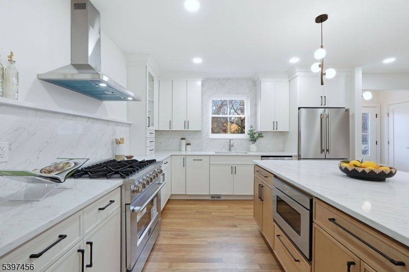 8 Mountainview Road Millburn, NJ 07041 - Photo 7 of 46 a kitchen with stainless steel appliances a sink stove and refrigerator