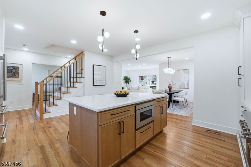 8 Mountainview Road Millburn, NJ 07041 - Photo 8 of 46 a kitchen with stainless steel appliances a stove top oven and a wooden floor