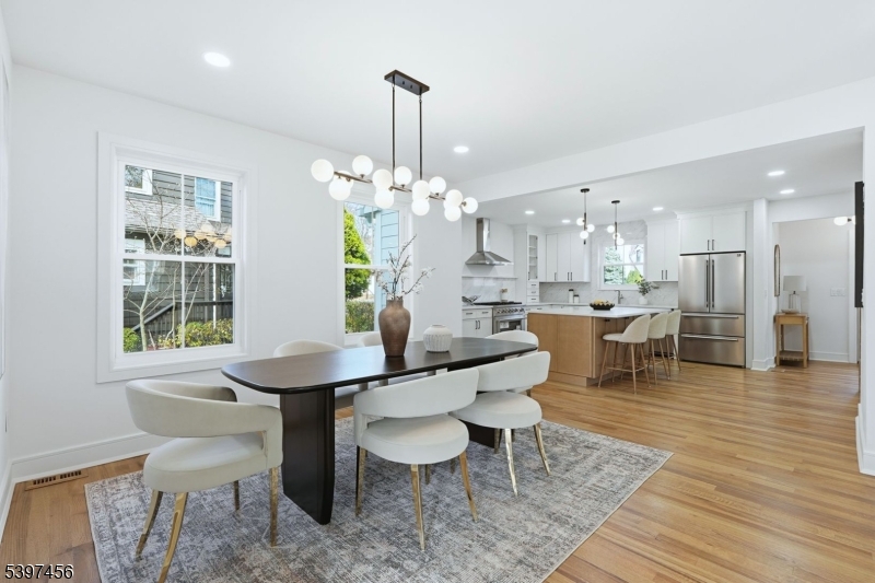8 Mountainview Road Millburn, NJ 07041 - Photo 10 of 46 a dining room with furniture a chandelier and wooden floor