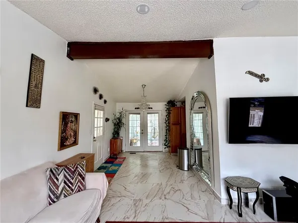a living room with furniture and a flat screen tv