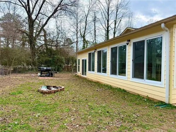 a backyard of a house with barbeque oven