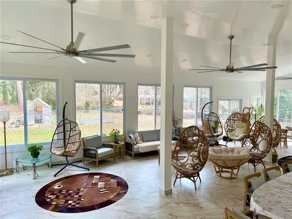 a room with lots of furniture and a large window