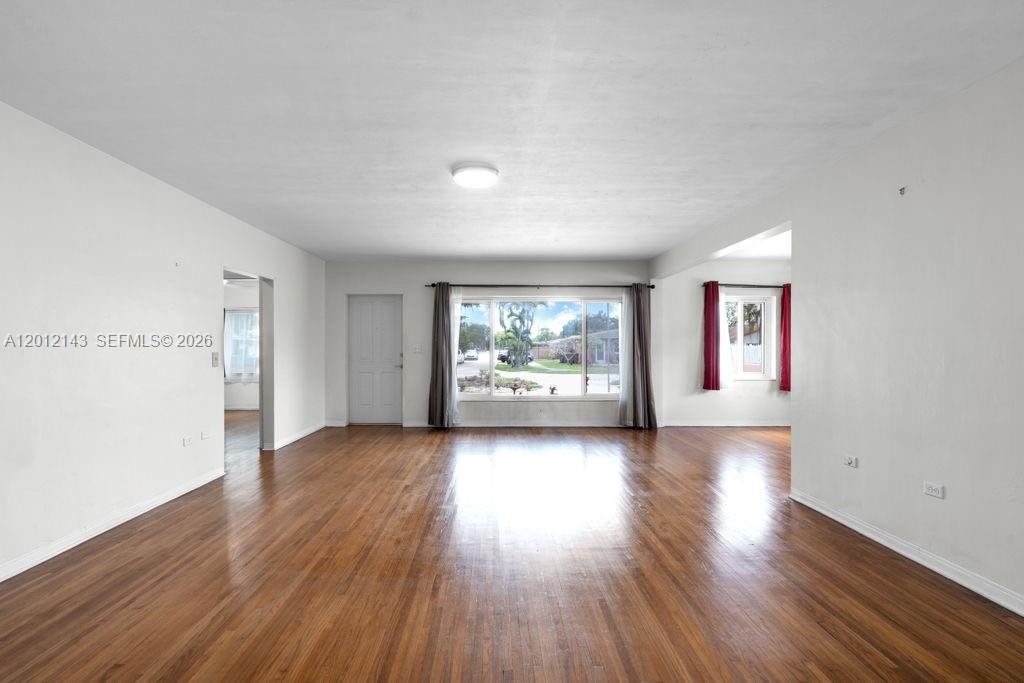 5651 Northwest 3rd Street Miami, FL 33126 - Photo 4 of 21 an empty room with wooden floor and windows
