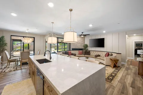 a living room with furniture and kitchen view