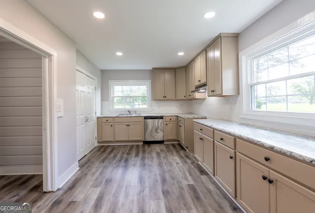 a kitchen with sink cabinets and window