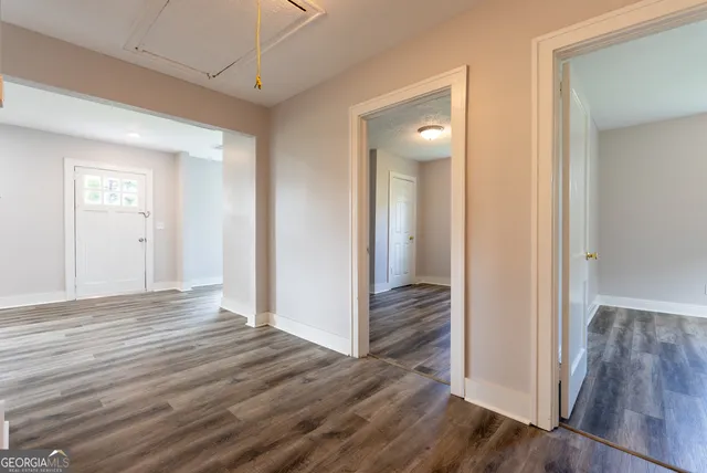 a view of a hallway with wooden floor