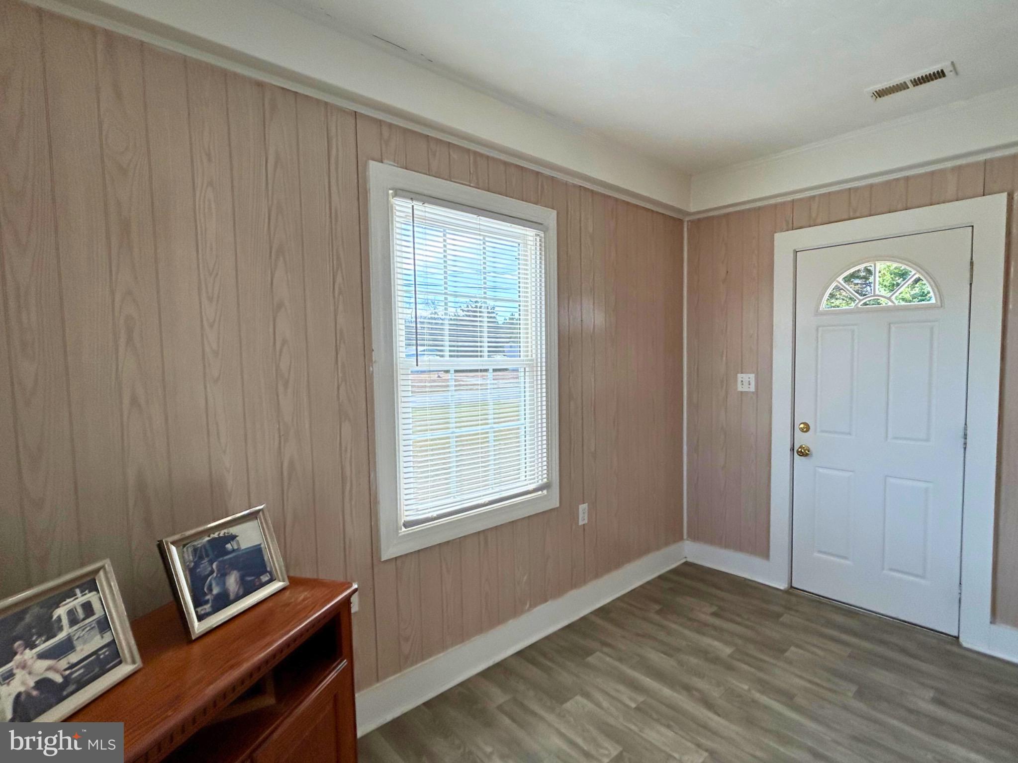 383 Lake Road Lottsburg, VA 22511 - Photo 13 of 18 a view of an empty room with a window and wooden floor