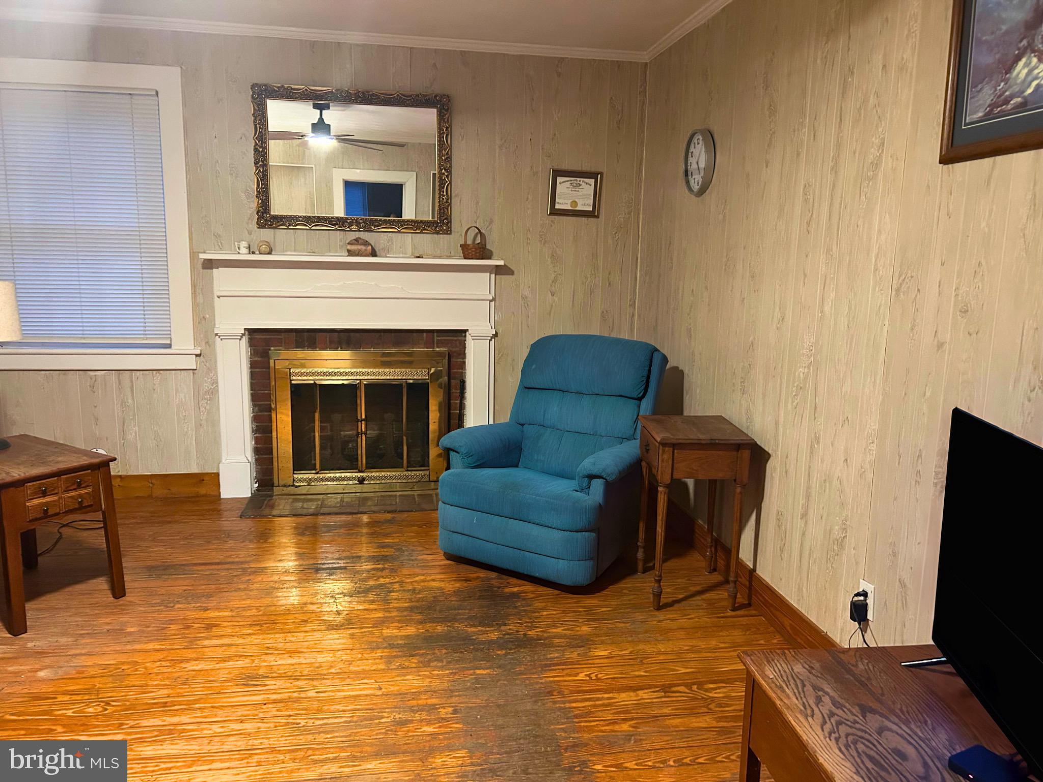 383 Lake Road Lottsburg, VA 22511 - Photo 14 of 18 a living room with furniture and a fireplace