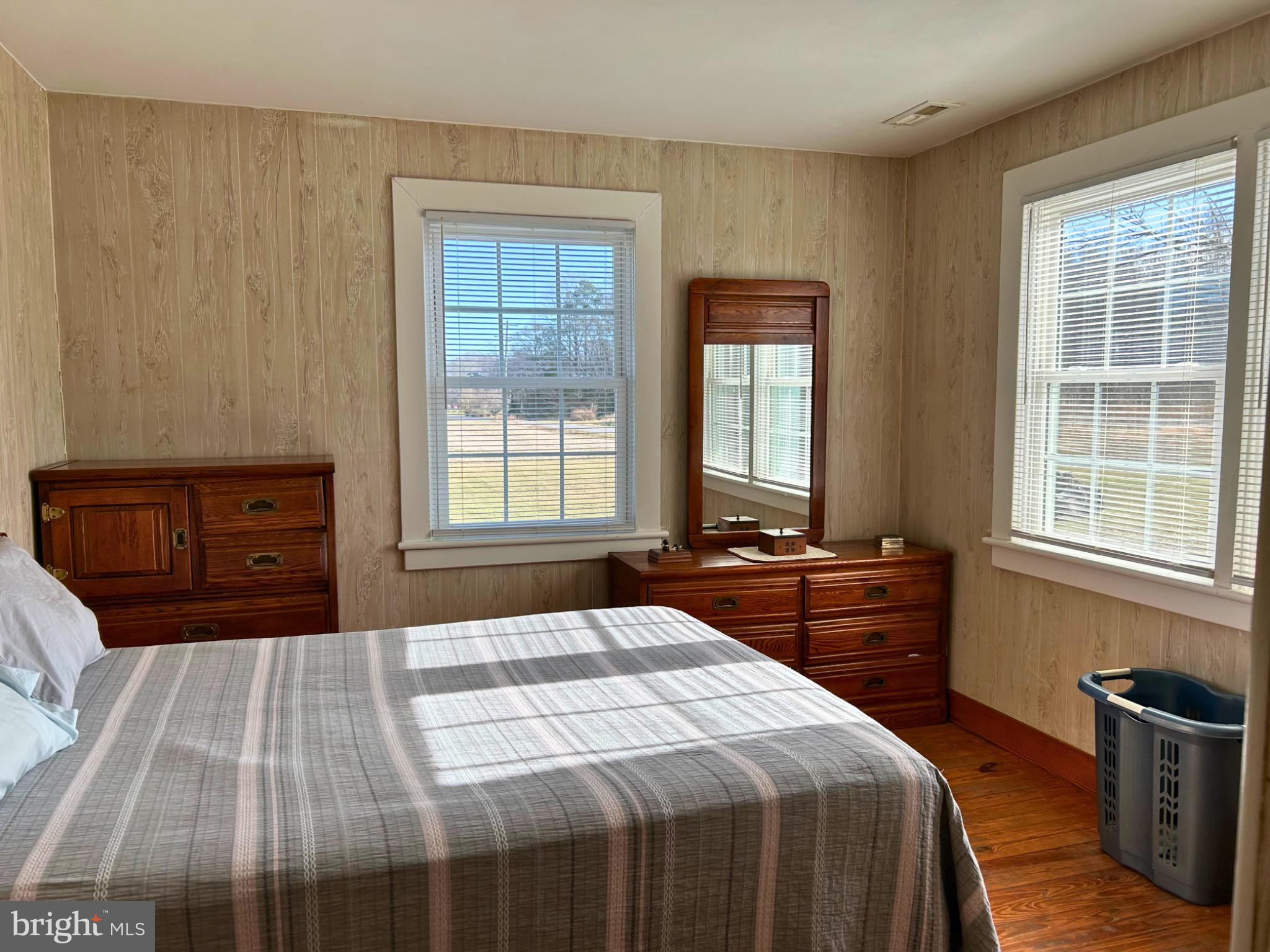 383 Lake Road Lottsburg, VA 22511 - Photo 3 of 18 a bedroom with a bed and wooden floor