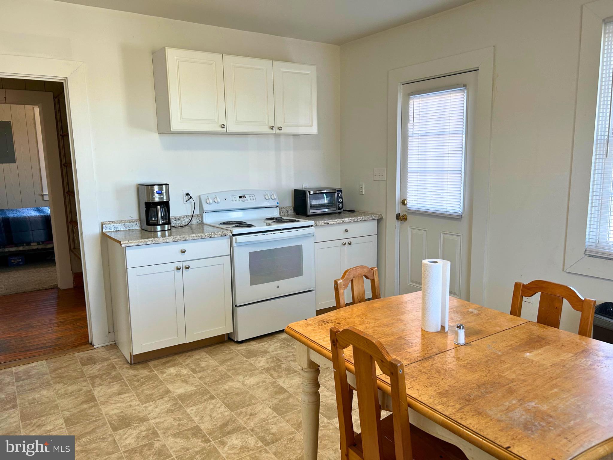 383 Lake Road Lottsburg, VA 22511 - Photo 9 of 18 a kitchen with stainless steel appliances granite countertop a sink a stove top oven a counter space and cabinets