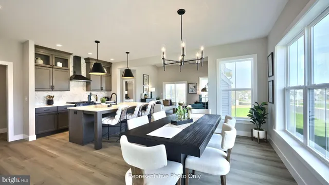 a large kitchen with a table and chairs
