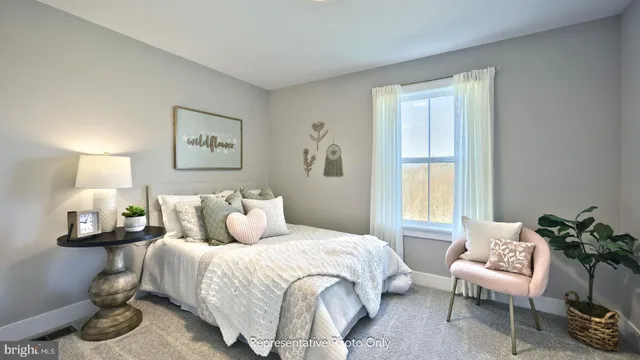 a bedroom with a bed and a chair