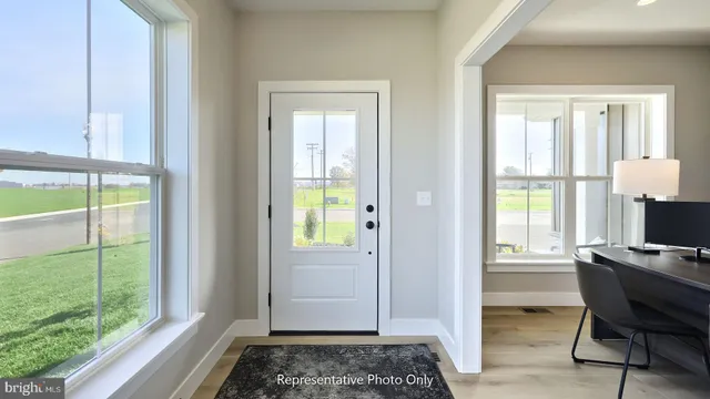 a view of a workspace with wooden floor and a window