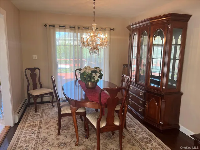 a view of a dining room with furniture and chandelier