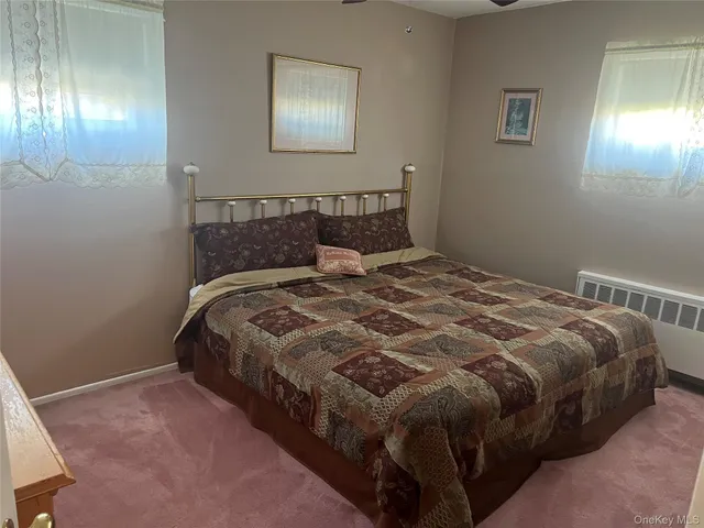 a large bed sitting in a bedroom next to a lamp