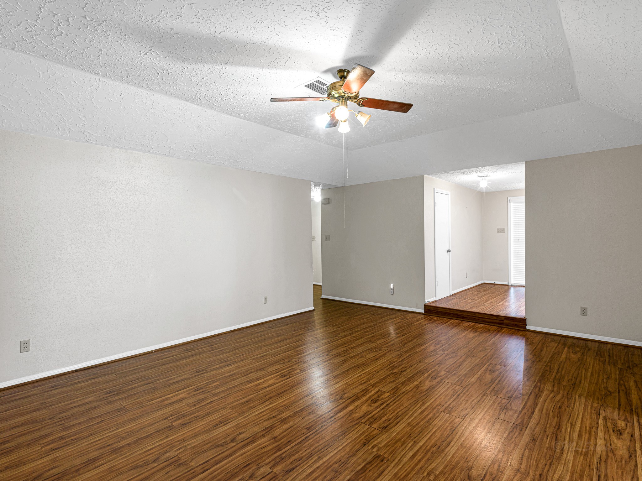 22906 Squirrel Tree Street Spring, TX 77389 - Photo 15 of 41 a view of an empty room with wooden floor and a ceiling fan