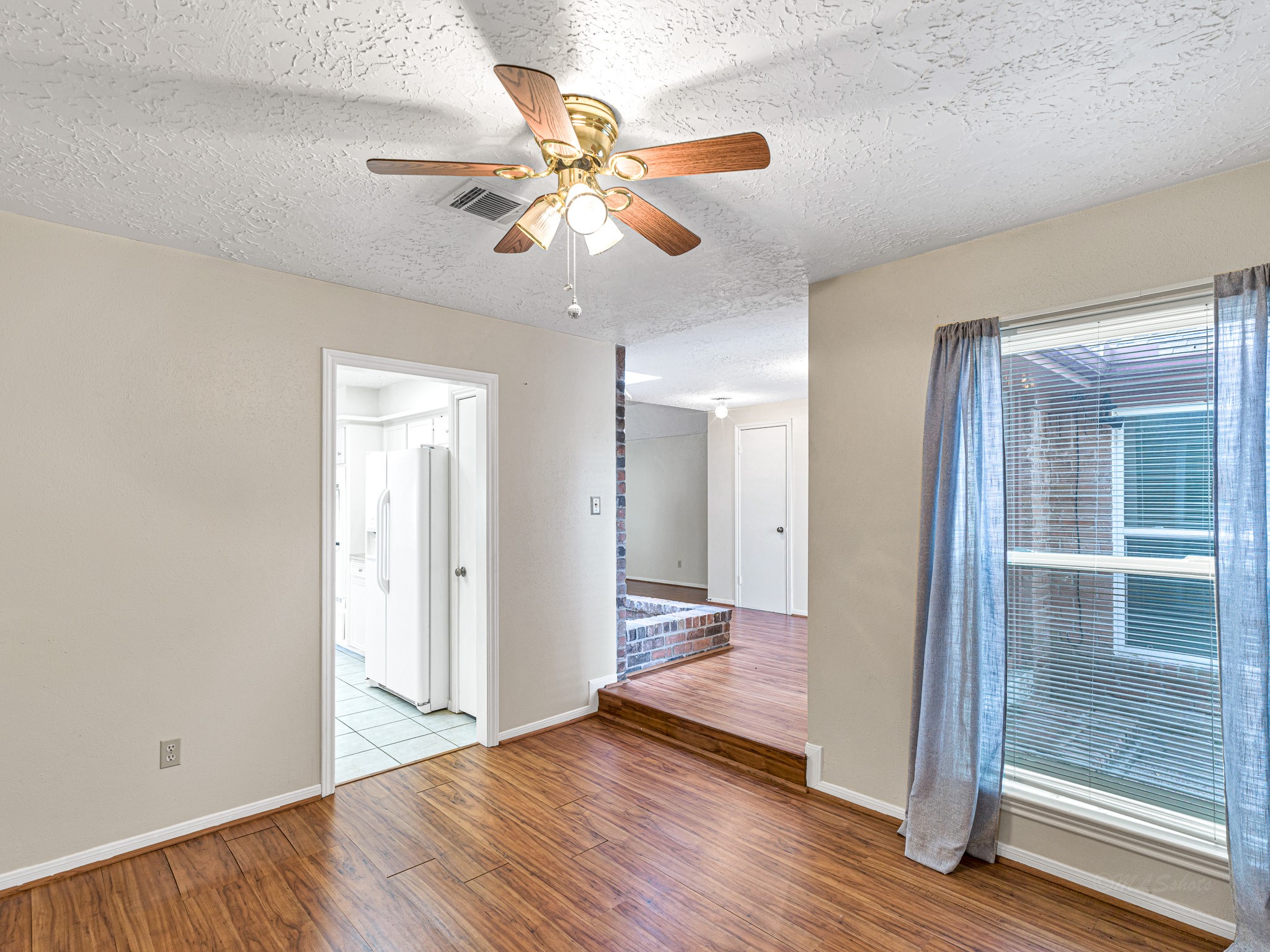 22906 Squirrel Tree Street Spring, TX 77389 - Photo 7 of 41 a view of an empty room with wooden floor and a window
