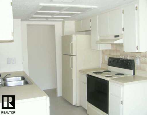 5946 Pennsylvania Avenue New Port Richey, FL 34652 - Photo 1 of 1 a kitchen with stainless steel appliances granite countertop a sink stove and refrigerator