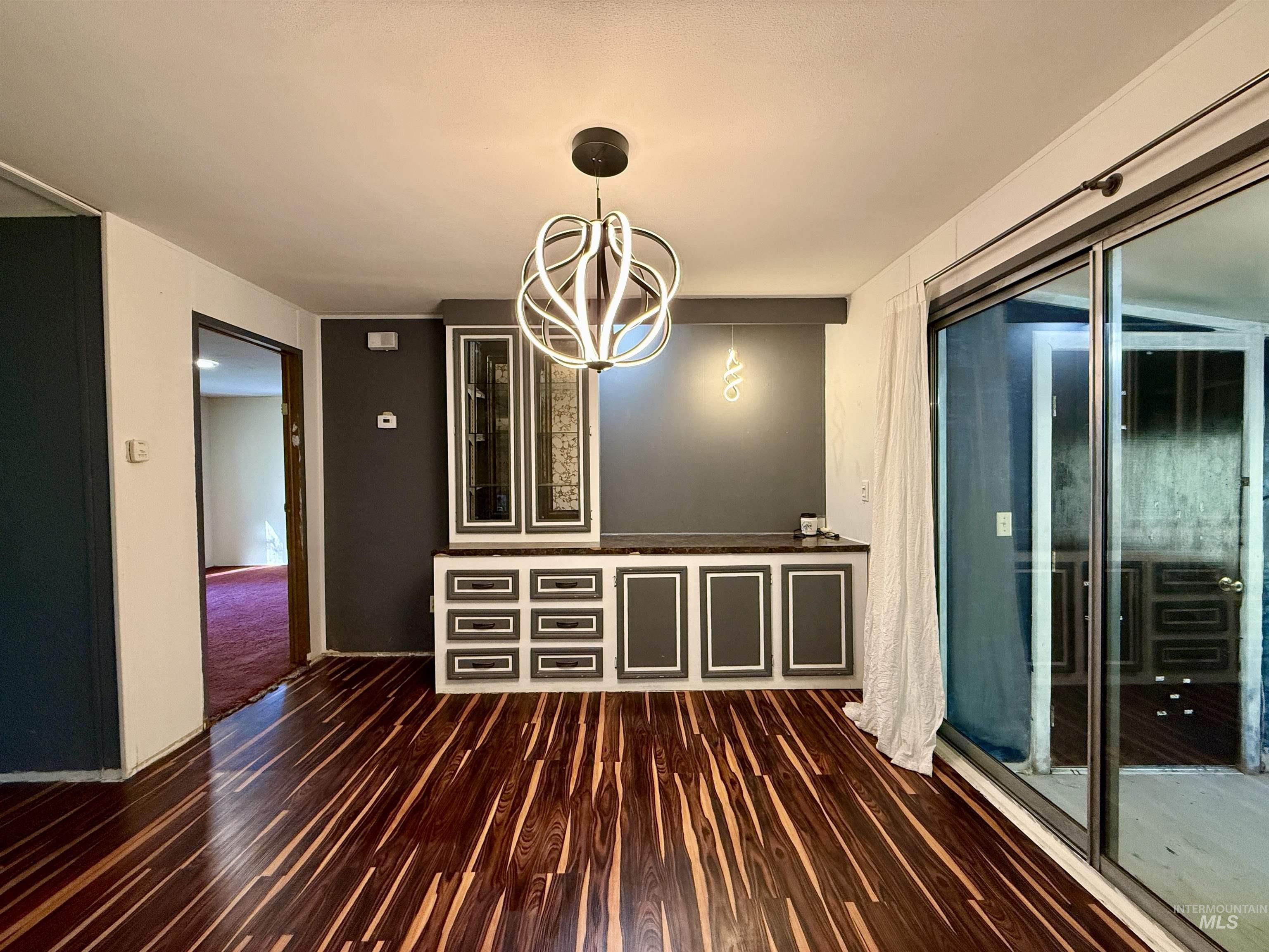 191 Battle Ridge Road Kooskia, ID 83539 - Photo 15 of 35 Unfurnished dining area featuring a chandelier and dark wood finished floors