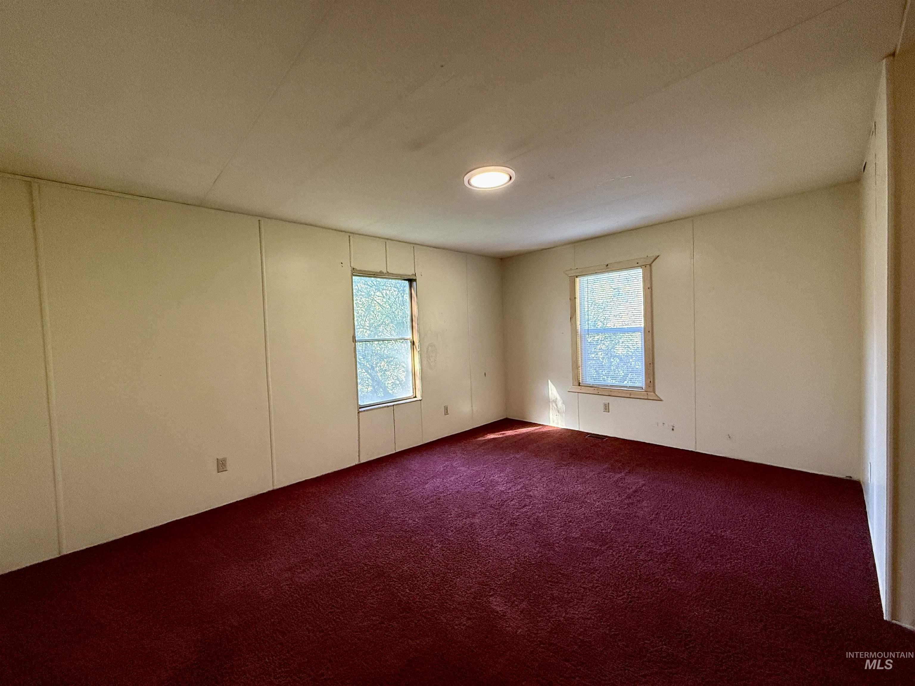 191 Battle Ridge Road Kooskia, ID 83539 - Photo 16 of 35 Unfurnished room with a decorative wall and dark colored carpet