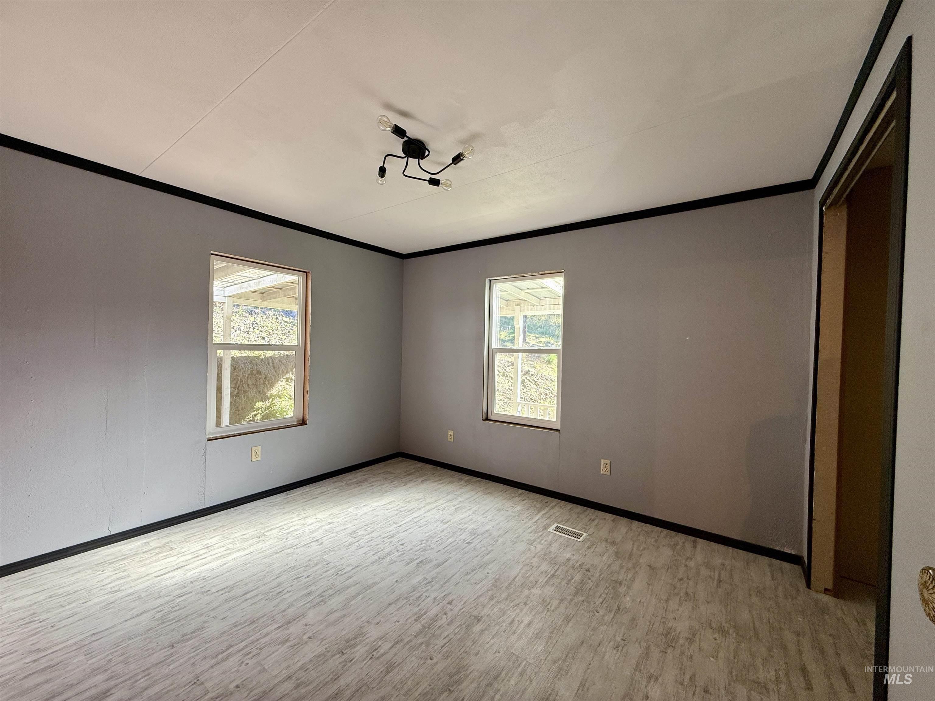 191 Battle Ridge Road Kooskia, ID 83539 - Photo 20 of 35 Unfurnished bedroom featuring ornamental molding and light wood finished floors