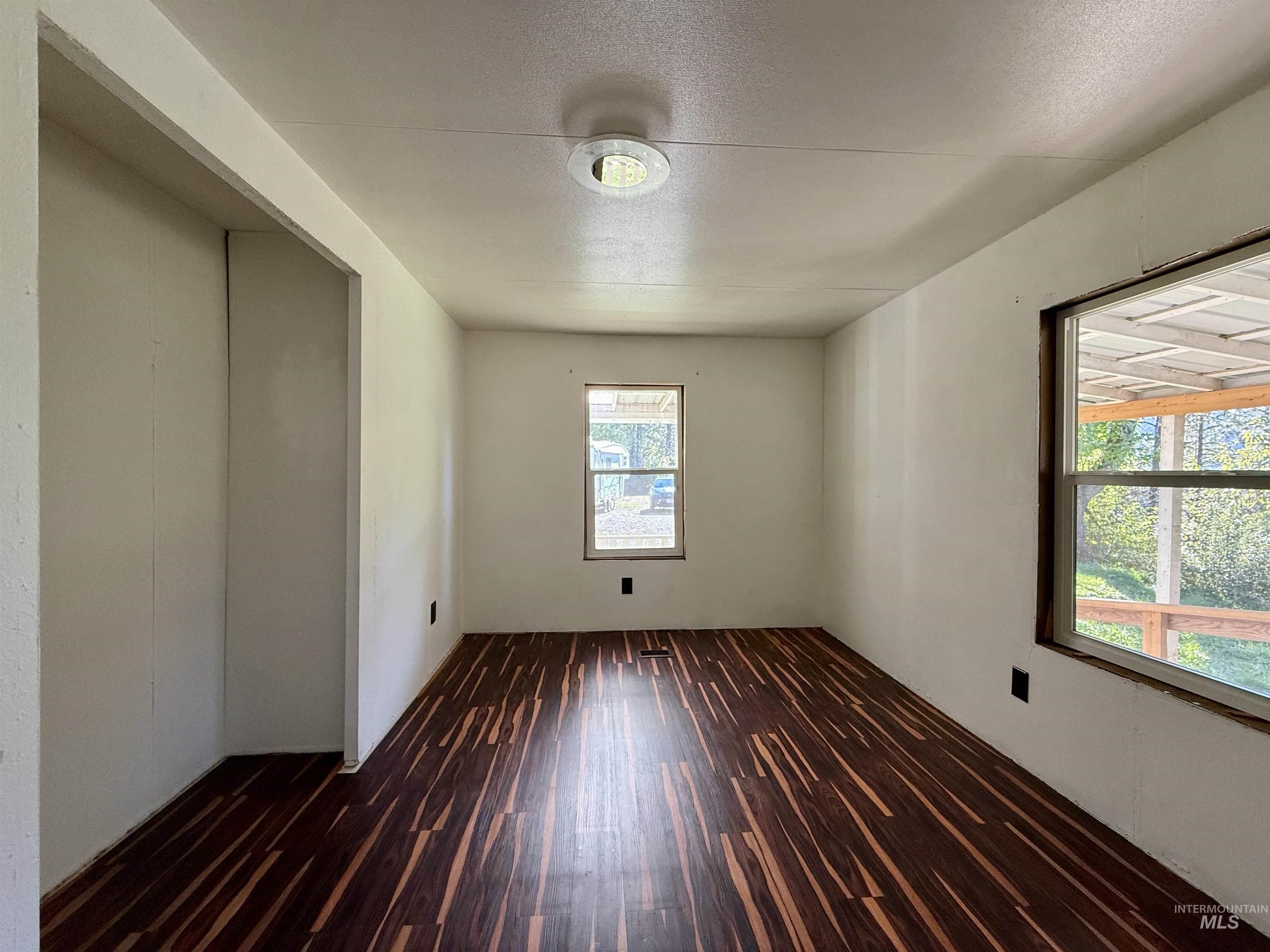 191 Battle Ridge Road Kooskia, ID 83539 - Photo 21 of 35 Spare room with dark wood-style flooring and a textured ceiling