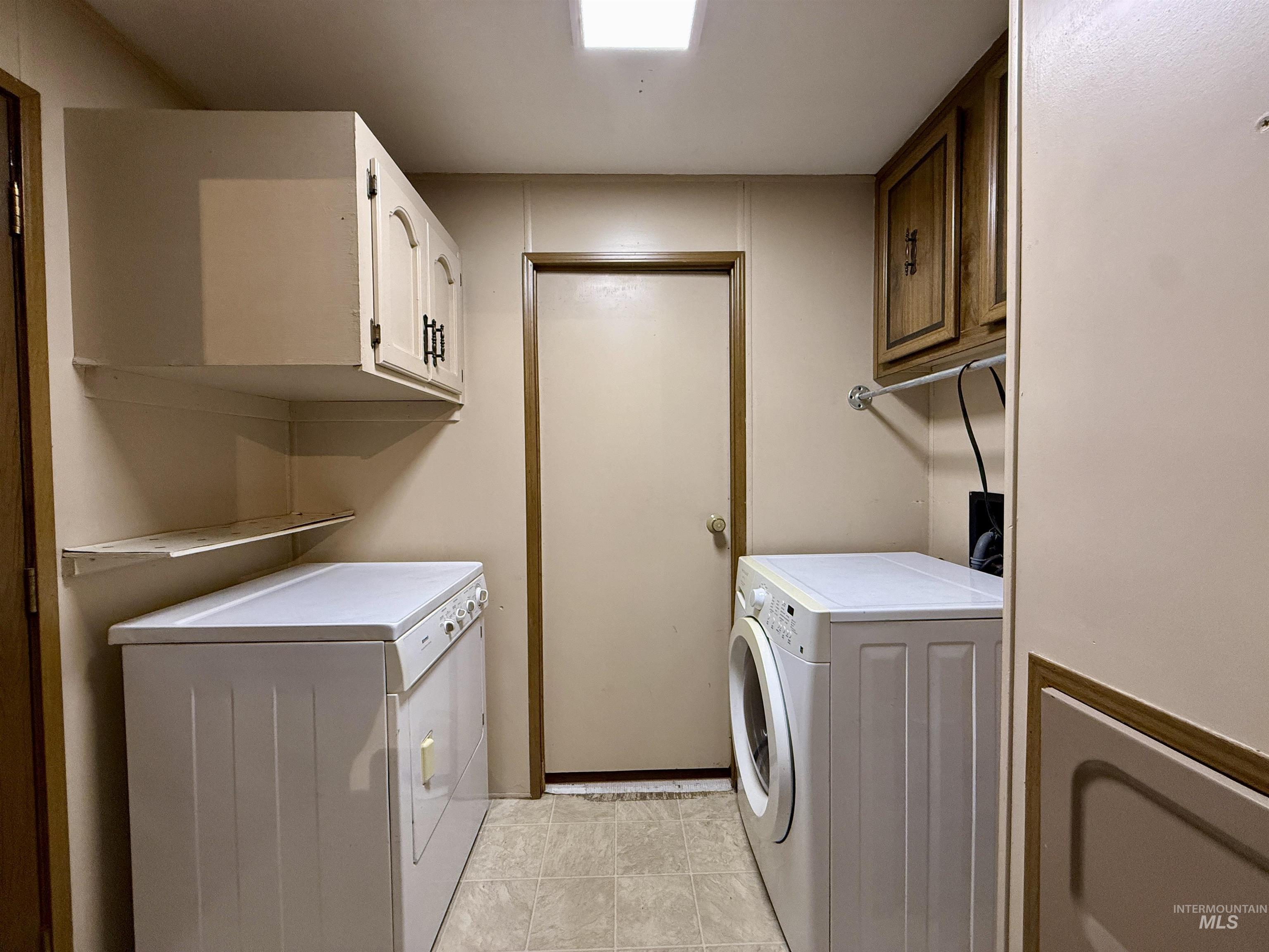 191 Battle Ridge Road Kooskia, ID 83539 - Photo 24 of 35 Laundry area featuring independent washer and dryer, cabinet space, and light tile patterned floors