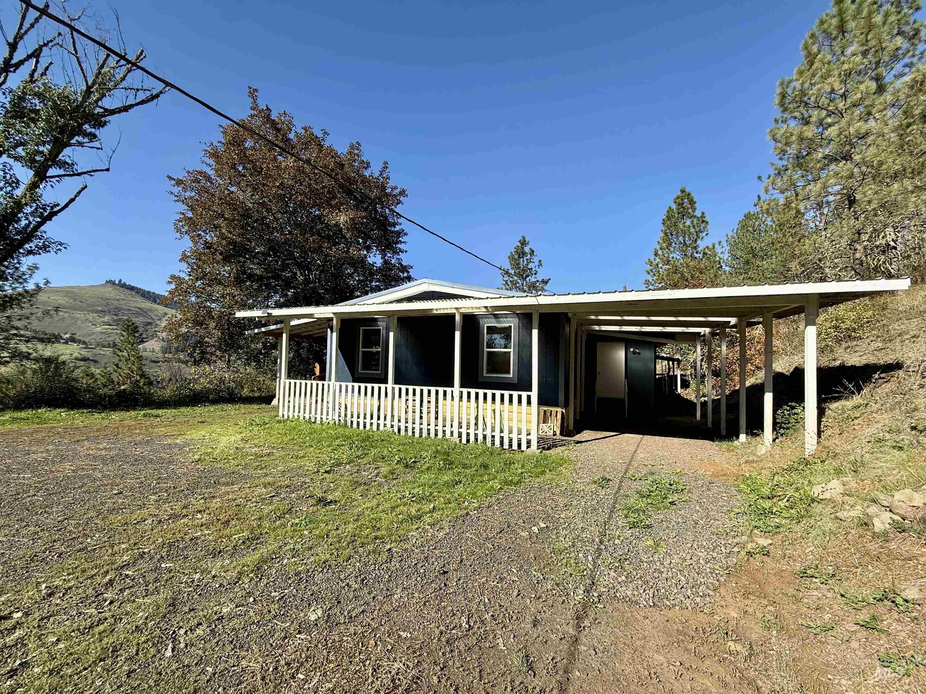 191 Battle Ridge Road Kooskia, ID 83539 - Photo 3 of 35 View of front of home with a carport, a front yard, and driveway