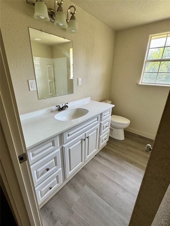 211 Sperry Lane Red Oak, TX 75154 - Photo 11 of 16 a spacious bathroom with a double vanity sink toilet and a mirror