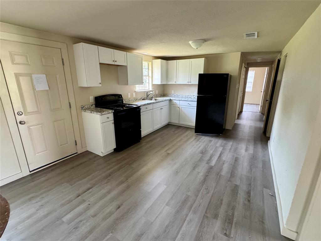 211 Sperry Lane Red Oak, TX 75154 - Photo 5 of 16 a kitchen with a refrigerator a sink and dishwasher with wooden floor