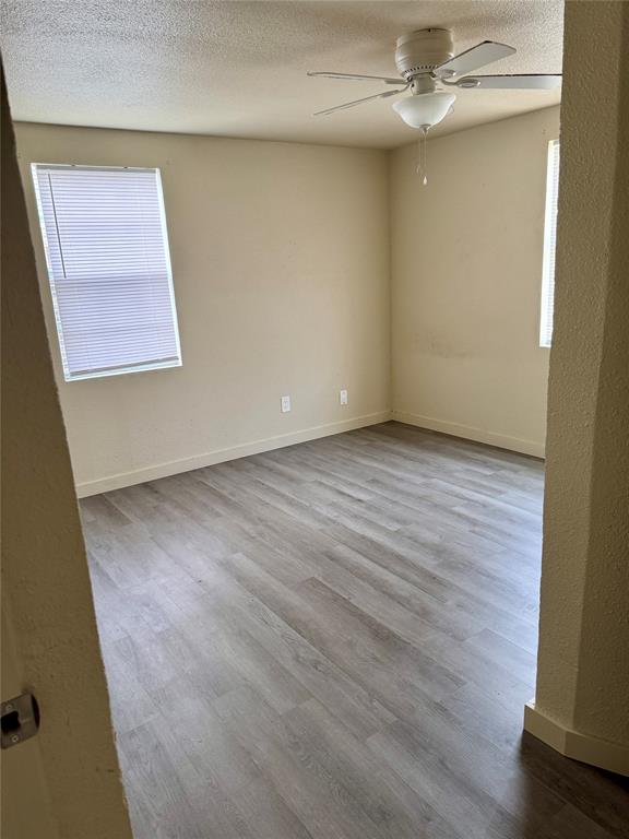 211 Sperry Lane Red Oak, TX 75154 - Photo 7 of 16 an empty room with wooden floor closet and windows