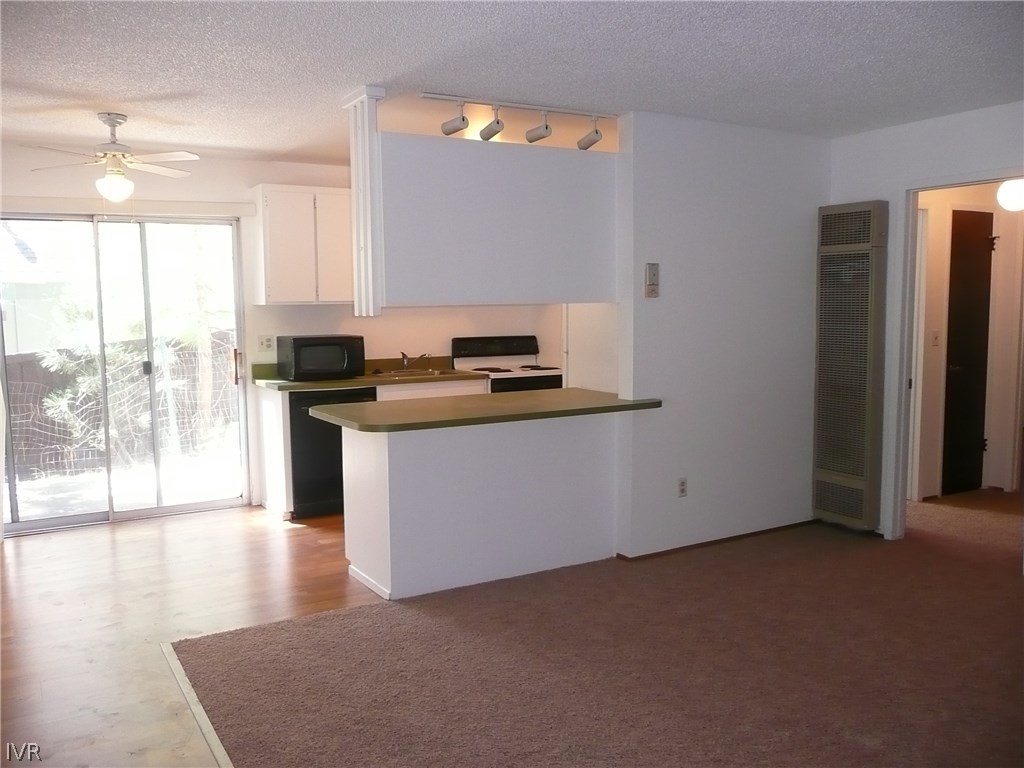 609 Village Boulevard Incline Village, NV 89451 - Photo 13 of 21 a kitchen with stainless steel appliances granite countertop a stove a sink and a refrigerator with wooden floor